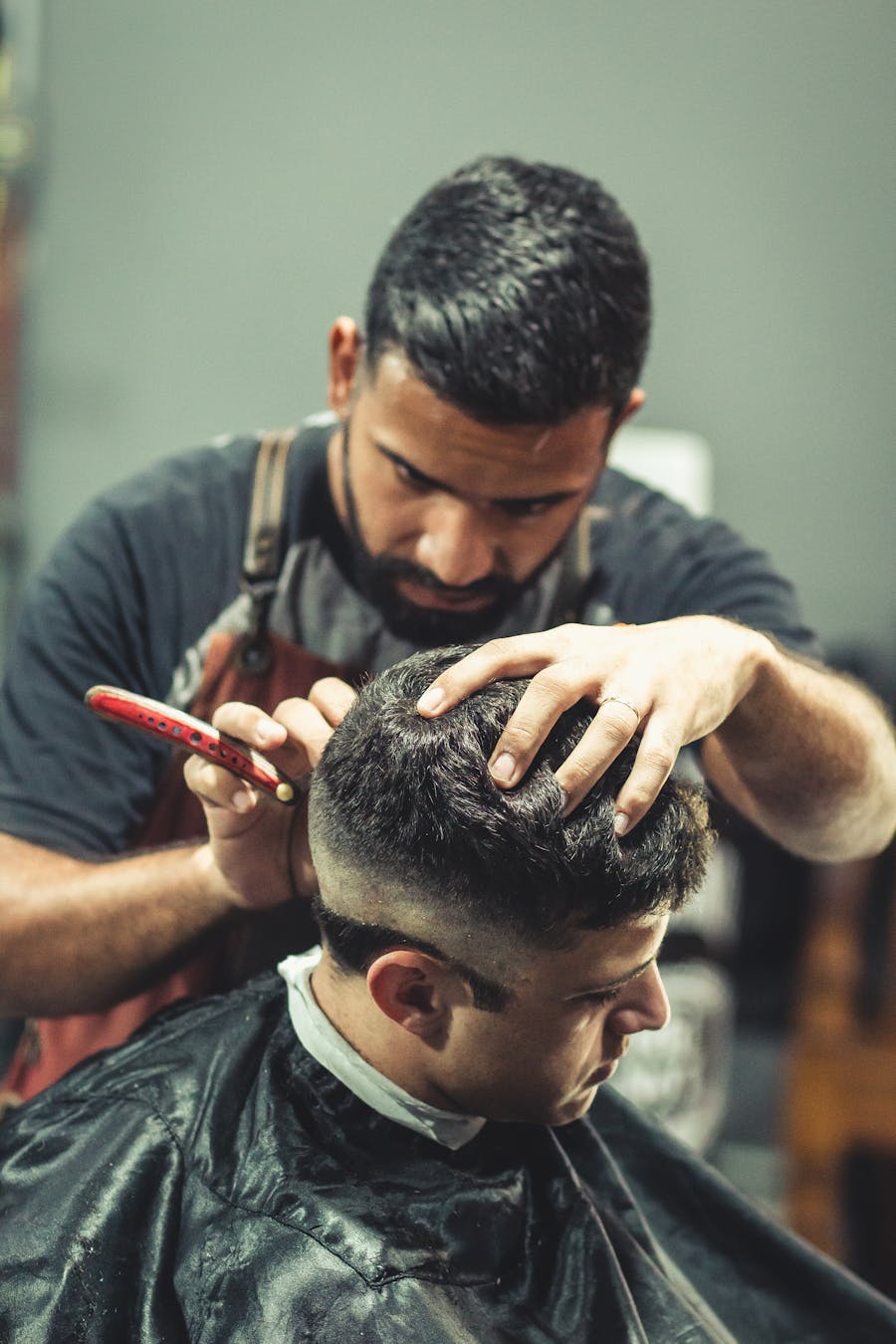 Sharp men's fade haircut being shaped by the barber
