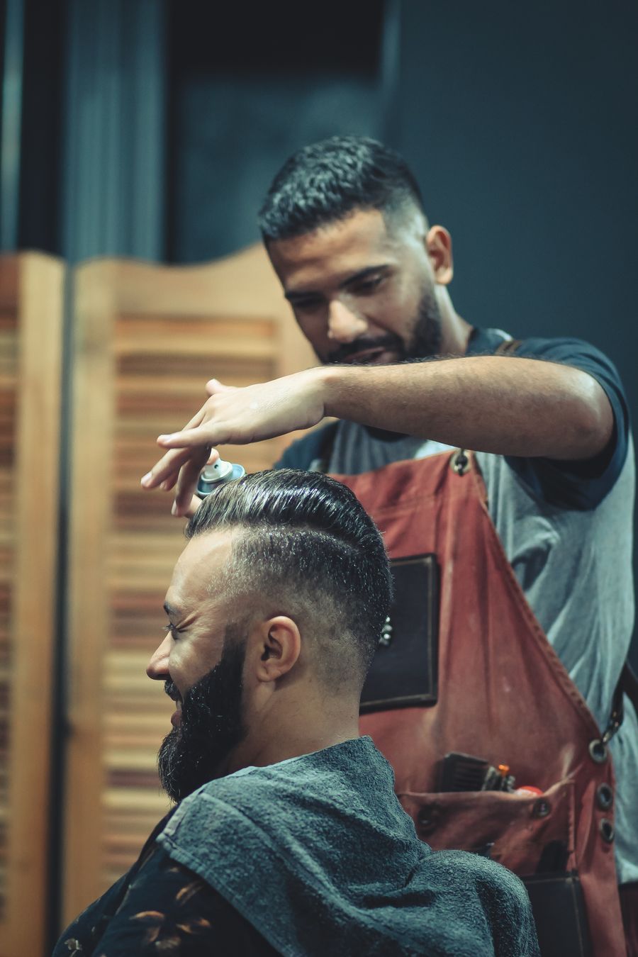 Slick pompadour with a skin fade and full beard