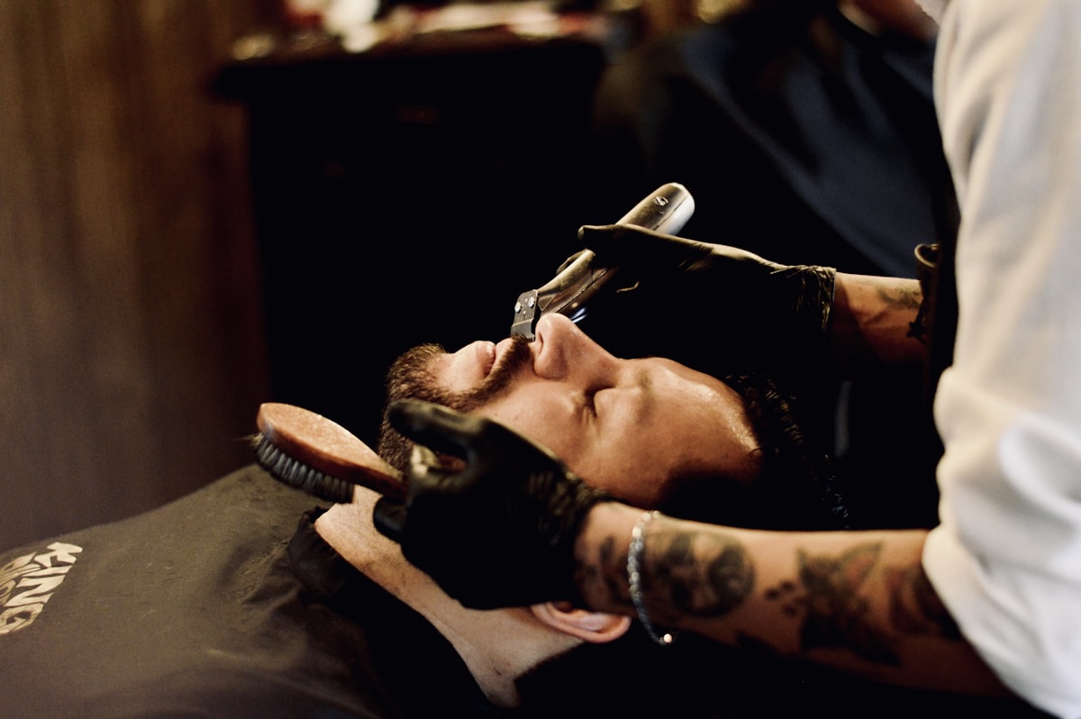Barber giving a straight-razor shave at Moe's Barbershop